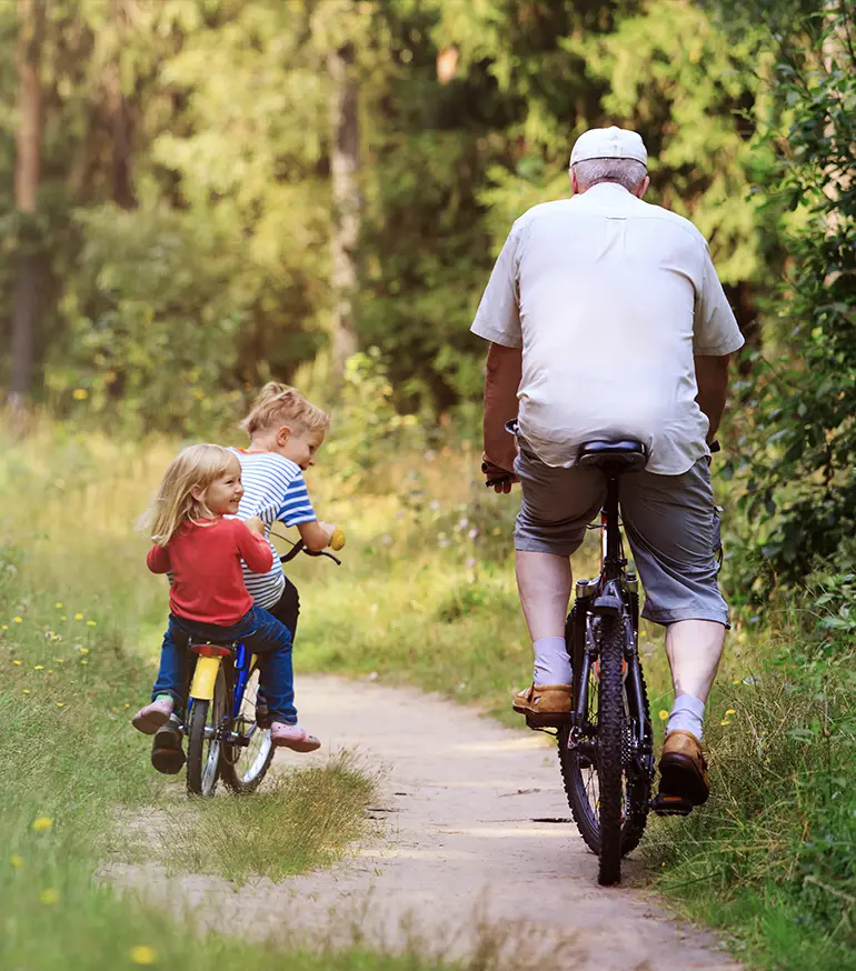 grandfather on a bike ride with his grandchildren retirement income strategies