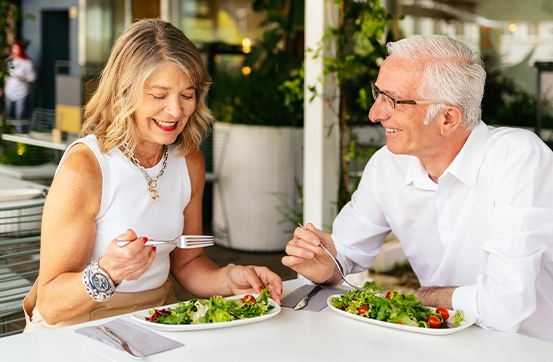 smiling couple at restaurant for retirement seminar