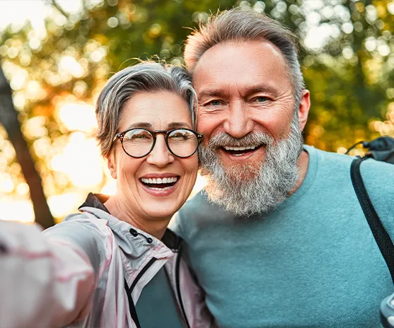smiling couple taking a selfie outdoors